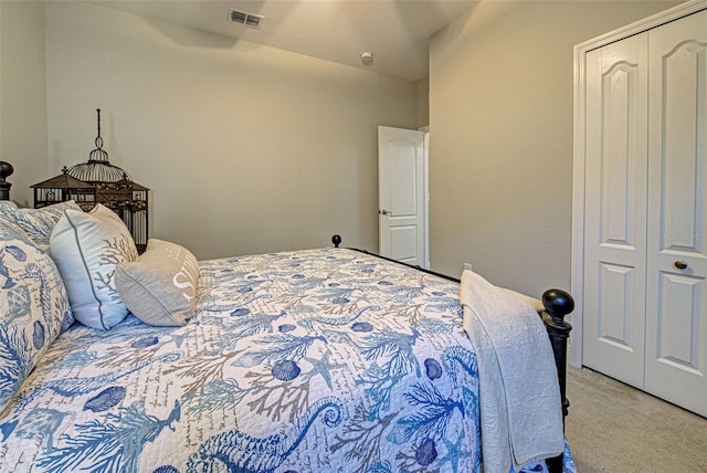 bedroom with light colored carpet and a closet