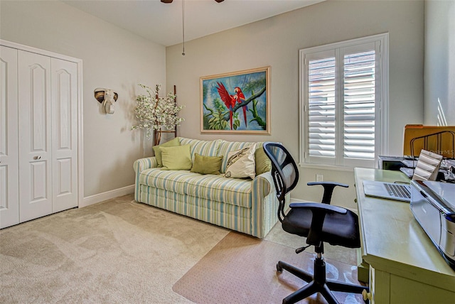 office area featuring ceiling fan and light carpet