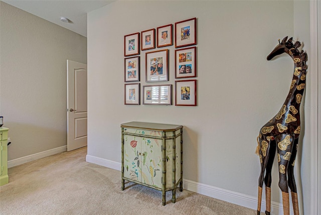 hall with light colored carpet