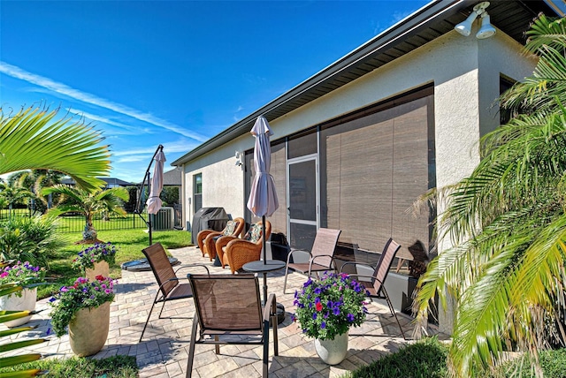 view of patio / terrace featuring a sunroom