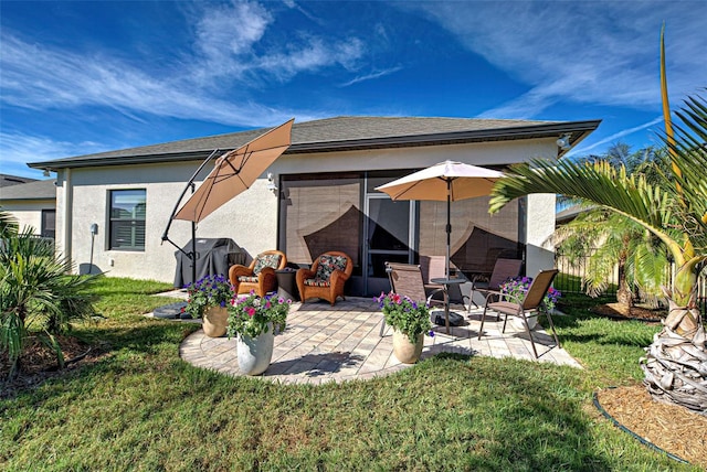 rear view of property with a patio area and a yard