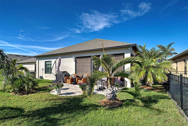 back of property featuring a lawn and a patio area