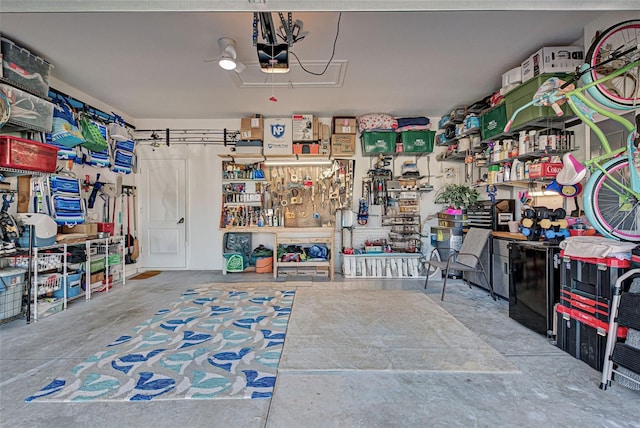 garage with a workshop area and a garage door opener