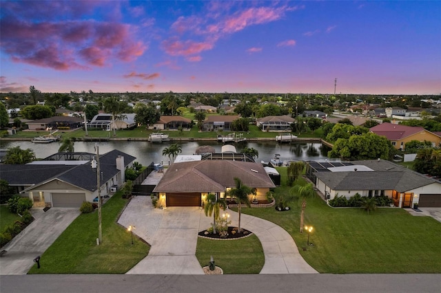 aerial view at dusk with a water view