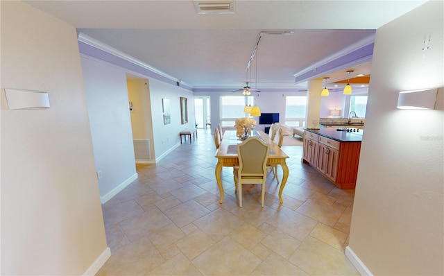 dining area with ornamental molding and ceiling fan