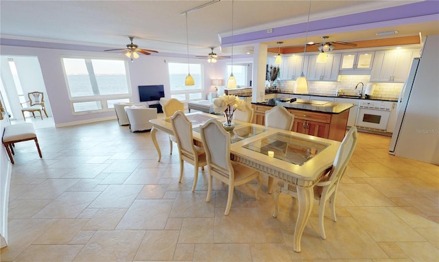 dining space with sink and ornamental molding