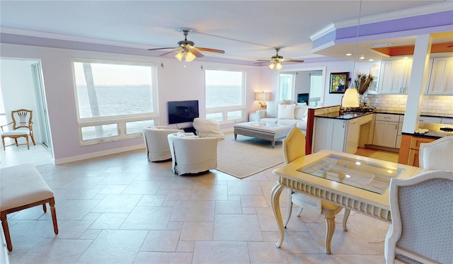 living room with ceiling fan and ornamental molding