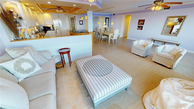 living room featuring sink, crown molding, light tile patterned floors, a raised ceiling, and ceiling fan