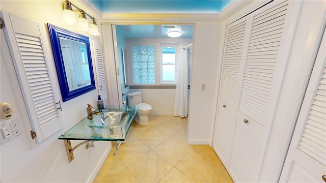 hallway with sink and light tile patterned floors