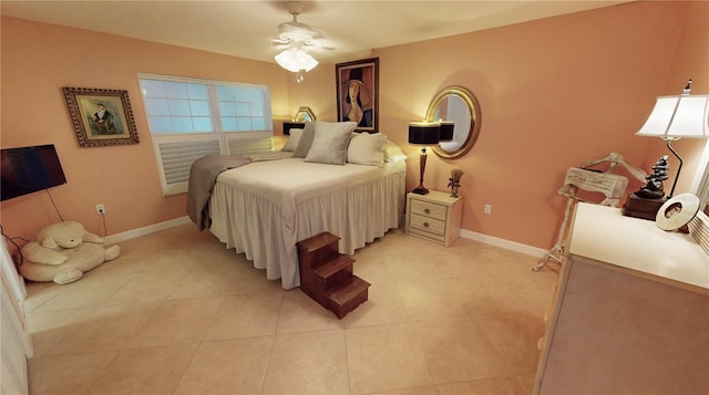 bedroom with ceiling fan and light tile patterned floors