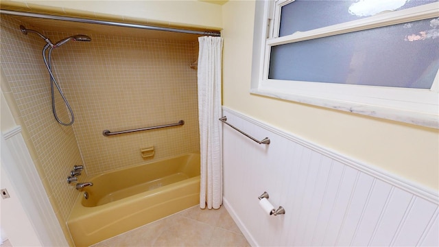 bathroom with tile patterned floors and shower / bath combo