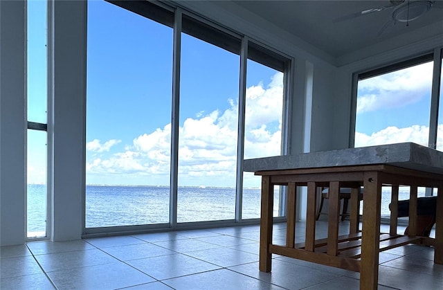 unfurnished sunroom with a water view