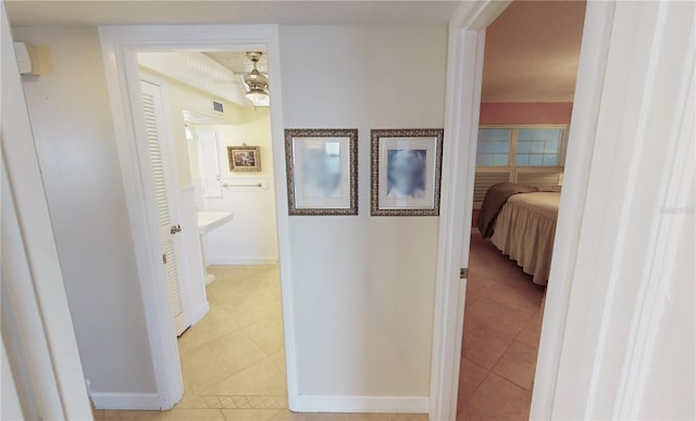 hall featuring light tile patterned flooring