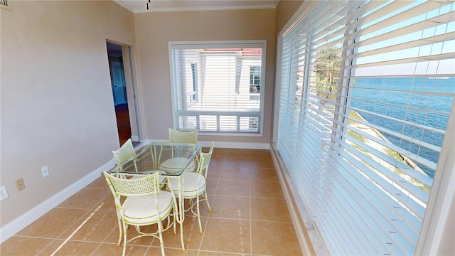 dining area featuring light tile patterned floors and ornamental molding