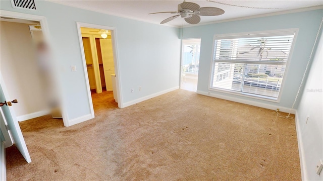 interior space with ornamental molding and ceiling fan