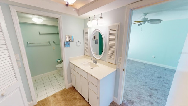 bathroom featuring ceiling fan, vanity, toilet, and tile patterned flooring