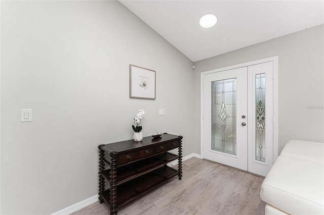 foyer featuring light hardwood / wood-style flooring and lofted ceiling