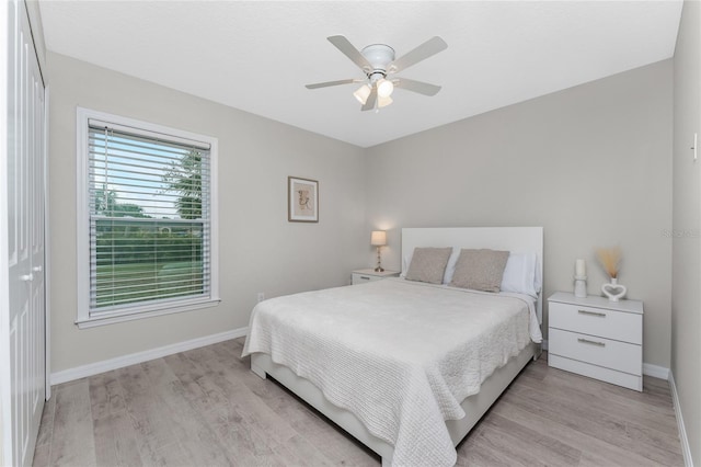 bedroom with ceiling fan, a closet, and light wood-type flooring