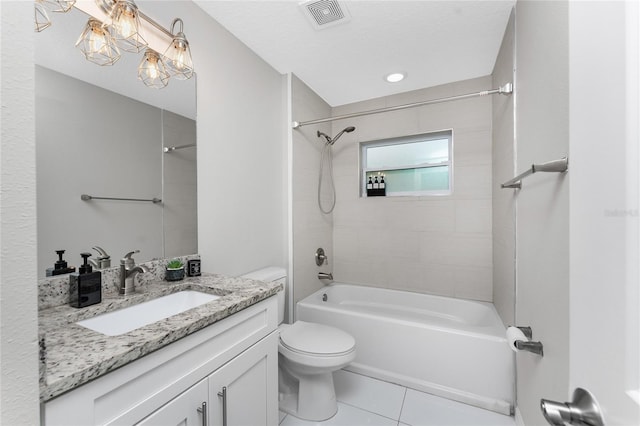 full bathroom featuring tile patterned floors, vanity, tiled shower / bath combo, a textured ceiling, and toilet