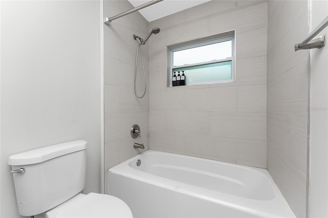 bathroom featuring toilet and tiled shower / bath