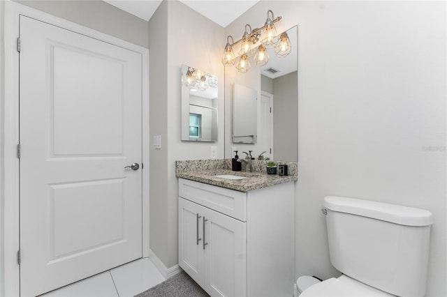 bathroom with tile patterned floors, vanity, and toilet