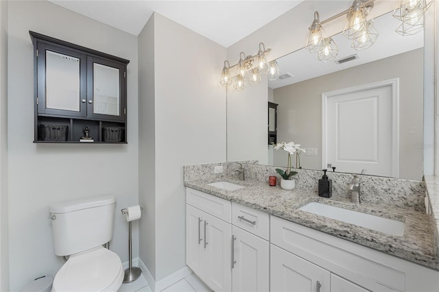 bathroom featuring tile patterned flooring, vanity, and toilet