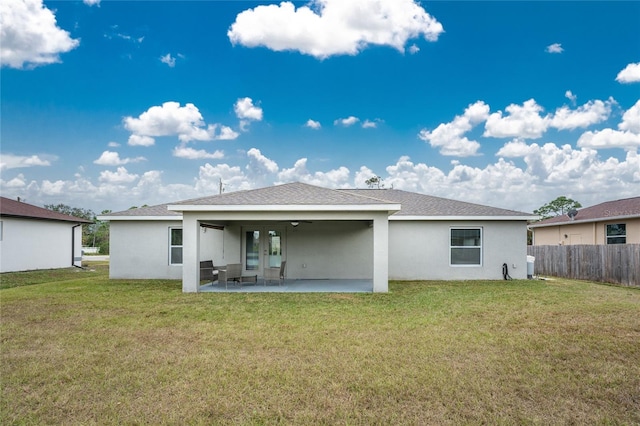 back of house with a patio, ceiling fan, and a lawn