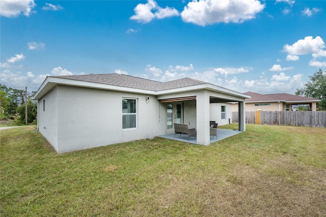 back of property with a lawn, a patio area, and outdoor lounge area