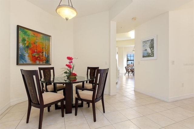 dining space featuring light tile patterned flooring