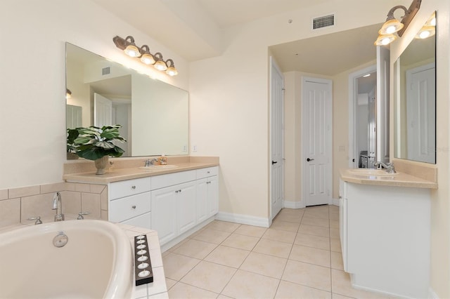 bathroom featuring tiled bath, tile patterned flooring, and vanity