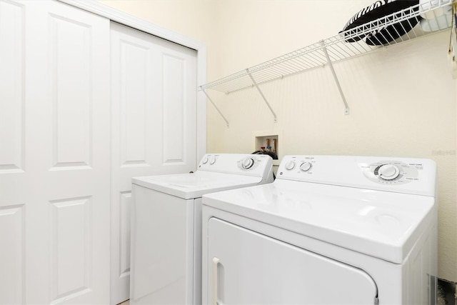 washroom featuring washer and clothes dryer