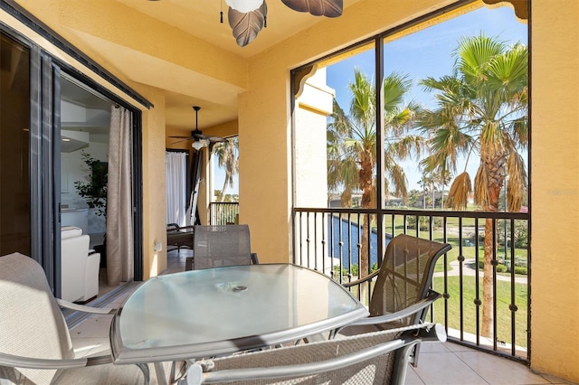 exterior space with ceiling fan and a water view