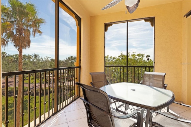 sunroom featuring ceiling fan and a healthy amount of sunlight