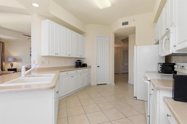 kitchen featuring white cabinets, range, light tile patterned flooring, and sink