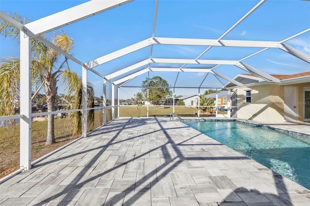 view of pool featuring a patio area and glass enclosure