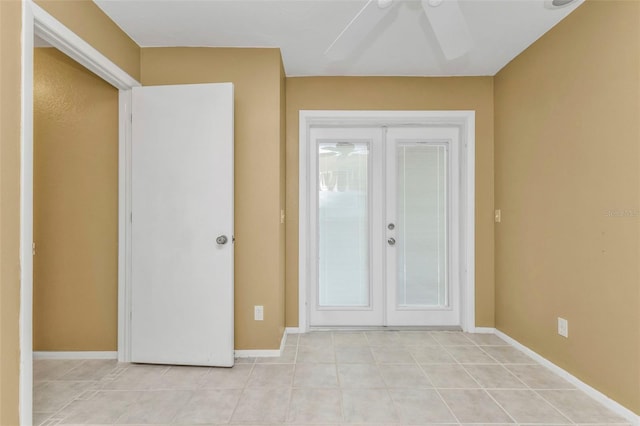 foyer entrance with ceiling fan and french doors