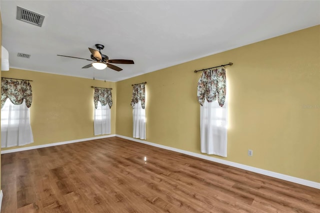 unfurnished room with hardwood / wood-style flooring and ceiling fan