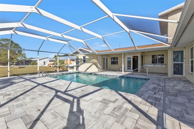 view of swimming pool featuring a lanai and a patio area