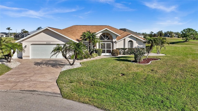 view of front facade with a garage and a front lawn