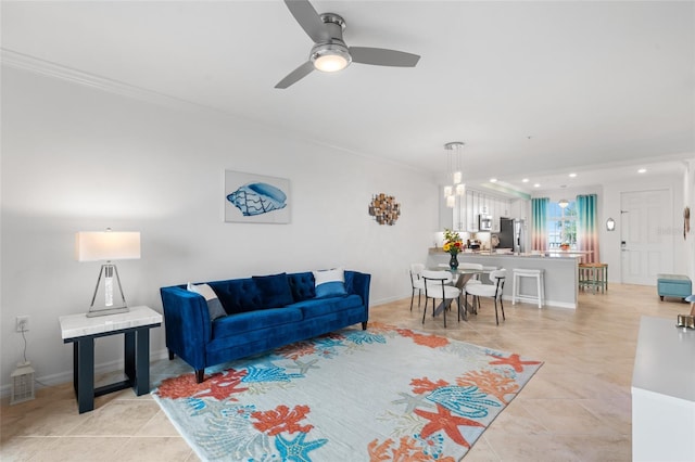 living room with light tile patterned floors, ceiling fan, and ornamental molding