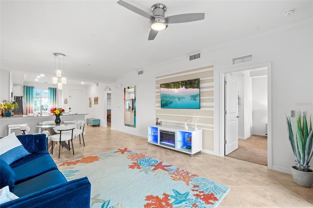 tiled living room with ceiling fan