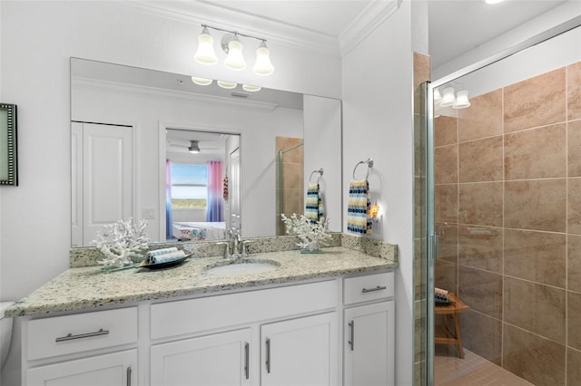 bathroom with vanity, a shower with shower door, and crown molding