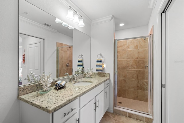 bathroom featuring tile patterned flooring, vanity, a shower with door, and ornamental molding