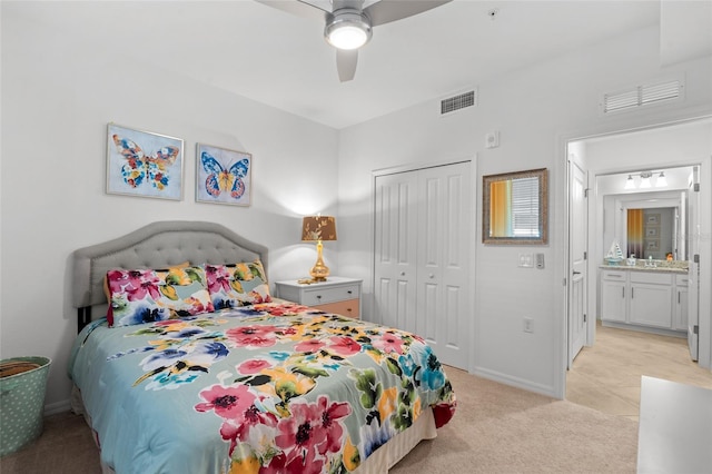 bedroom with ceiling fan, a closet, and light colored carpet