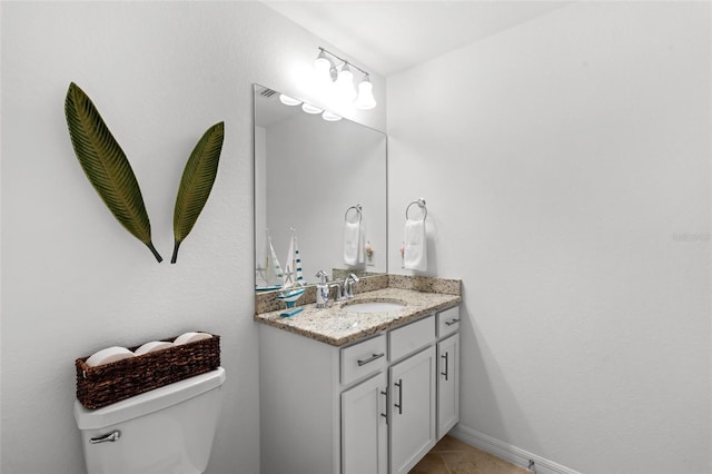 bathroom featuring tile patterned floors, vanity, and toilet