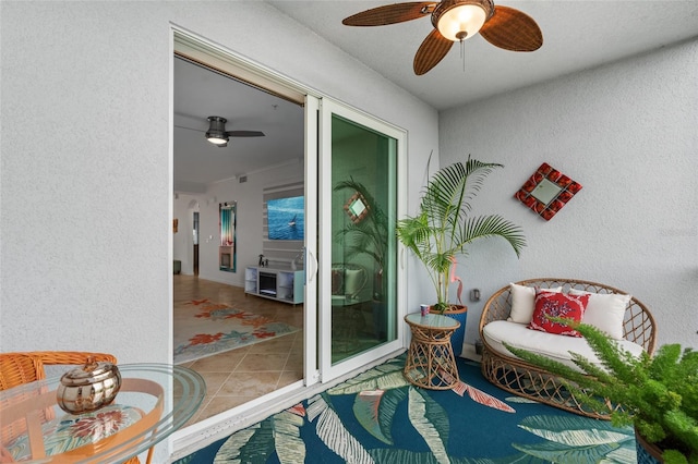 sitting room featuring ceiling fan and light tile patterned floors