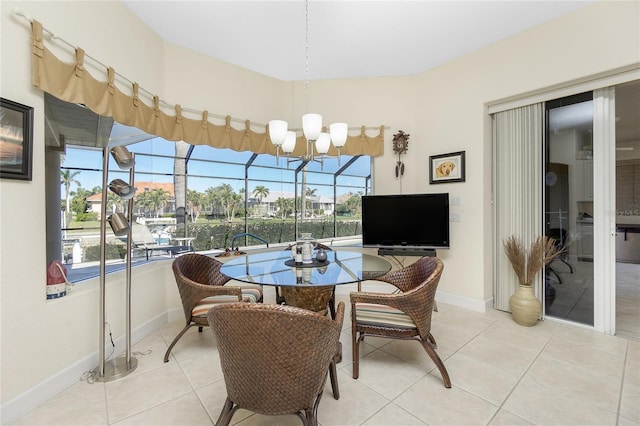 tiled dining room with a chandelier