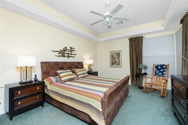 carpeted bedroom with a tray ceiling and ceiling fan