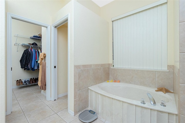 bathroom featuring tile patterned floors and a tub to relax in