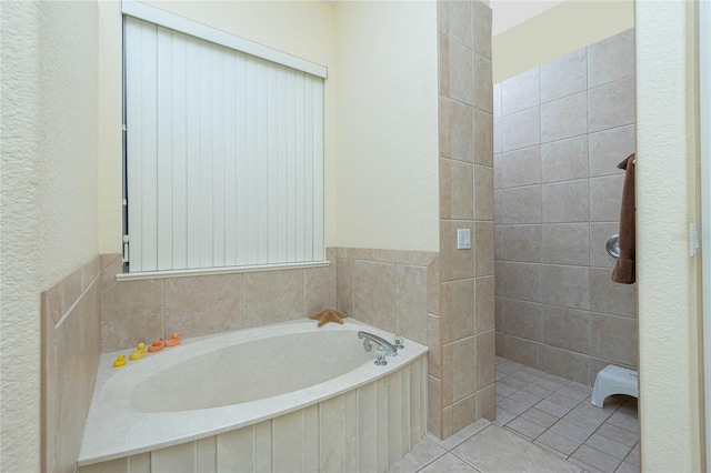 bathroom featuring tile patterned flooring and a washtub